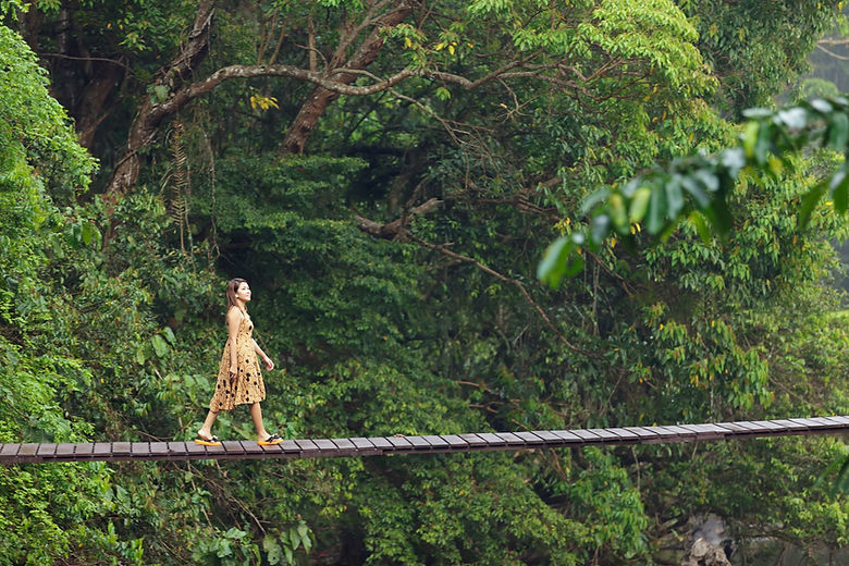 A woman walking on a bridge