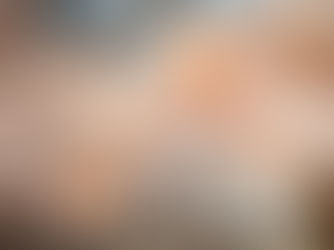 Delicate paper flowers suspended in a sunlit room with arched windows, creating a dreamy, ethereal atmosphere.