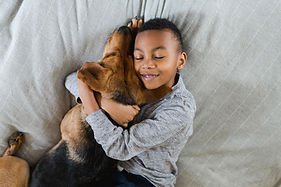 Menino abraçando cachorro