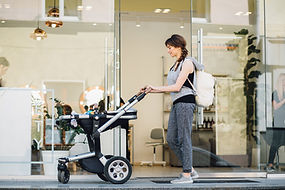 A new mother pushing her baby in a stroller