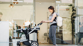 new parent pushing baby in stroller