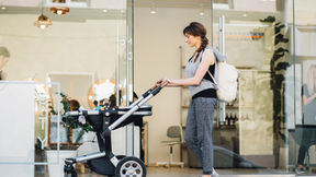 new parent pushing baby in stroller