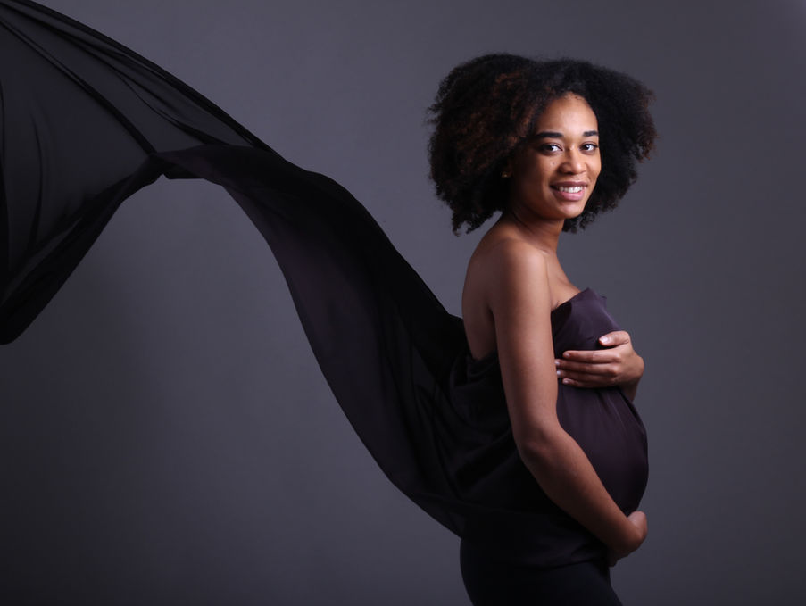 Maternity Photography by Blake Ferguson showcases a woman flaunting her Baby Bump in an elegant outfit captured in the Studio of Ontario, Canada.