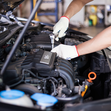 Hands of car mechanic in auto repair service