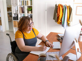 A local businesswoman takes notes at her desk while preparing for her day.