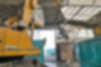Excavator in a scrap metal recycling plant