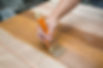 Applying protective varnish to wooden furniture