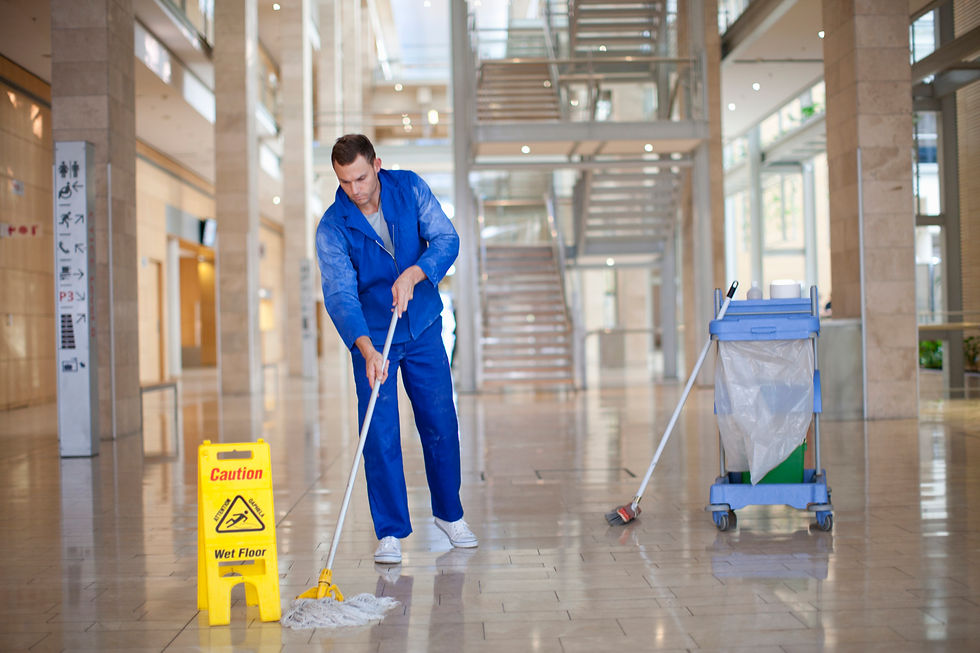 A professional mopping the floor at a commercial space