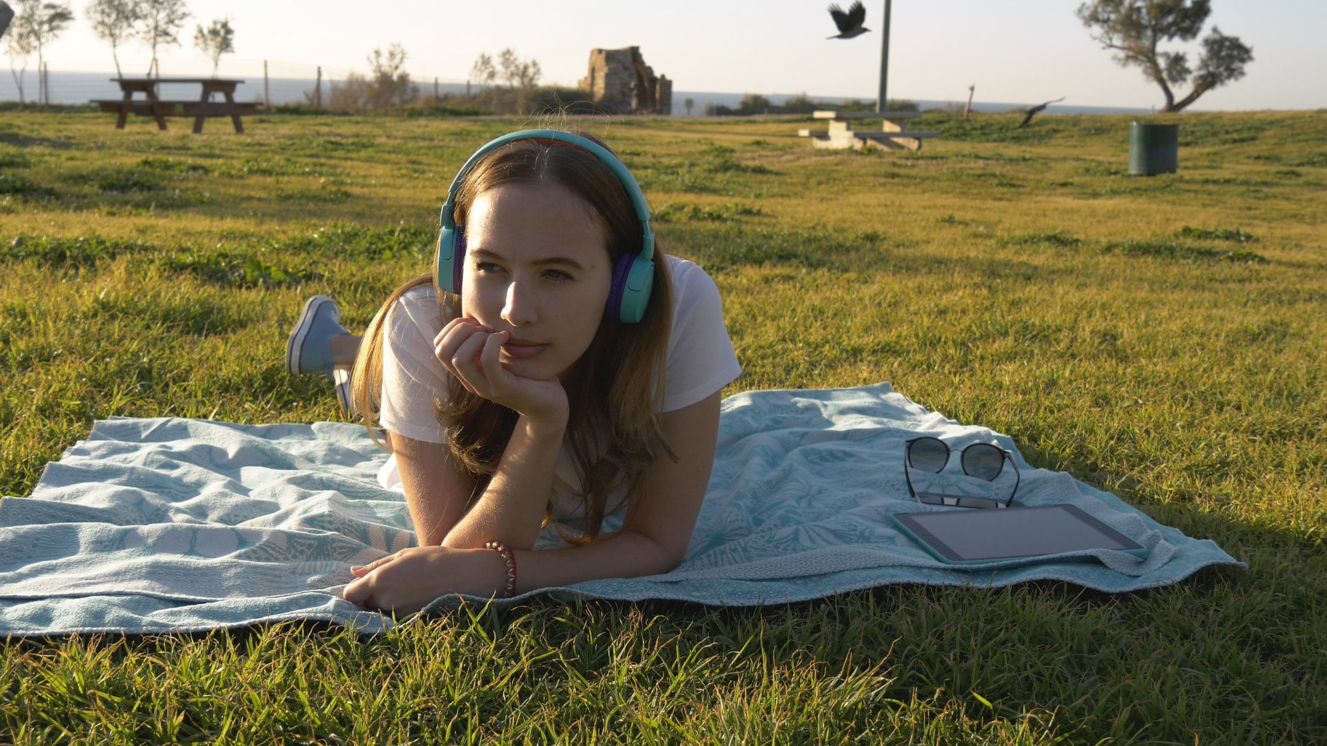 girl laying on the grass