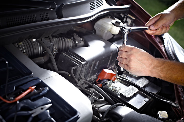 Car mechanic hands repairing an engine