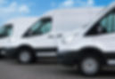 Outdoor shot of three white delivery vans in a row
