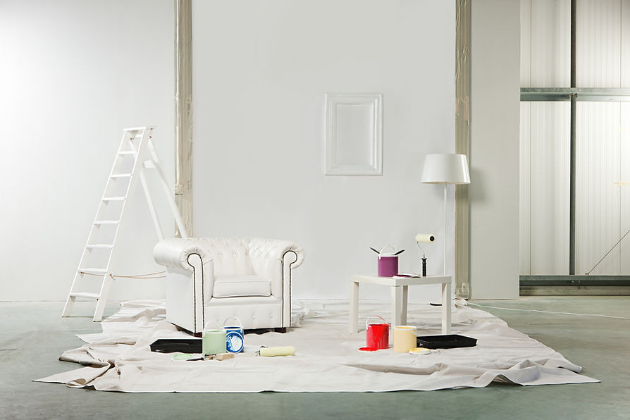 Room with paint pots and white armchair