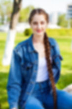 A portrait of a young person wearing denim