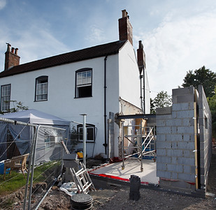 Early phase of extension walls being constructed