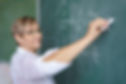 Teacher Writing on Blackboard