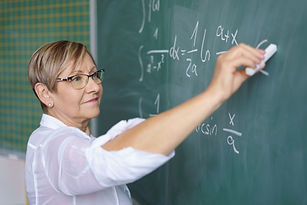 Teacher Writing on Blackboard