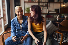 LGBTQIA couple sitting together and smiling