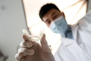 Dentist showing invisible braces