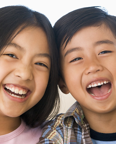 Asian siblings taking a picture kidz teethPaediatric Dentists