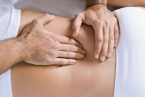 Chiropractor adjusting woman's spine