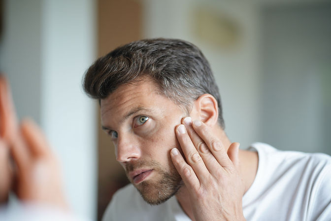 Man Looking in Mirror