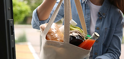 Woman delivering groceries in a tote bag