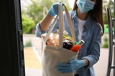 Woman delivering groceries in a tote bag