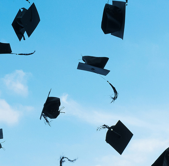 Graduation Caps Flying