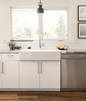 Bright white kitchen with a sink and pendant light