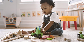 Kid Playing with Wooden Toys