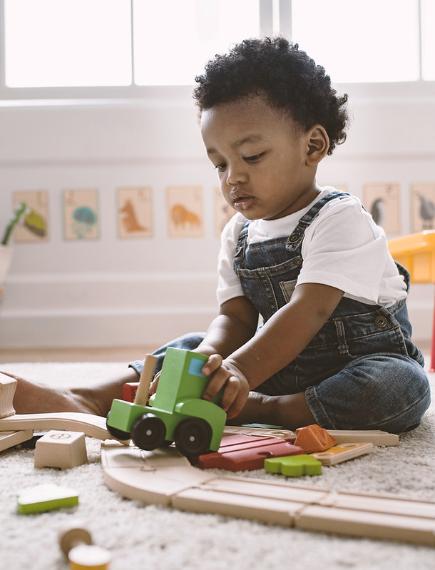 Kid Playing with Wooden Toys