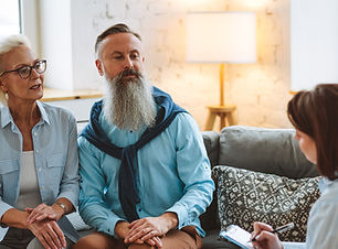 Sailboats in the water with the sun on the horizon