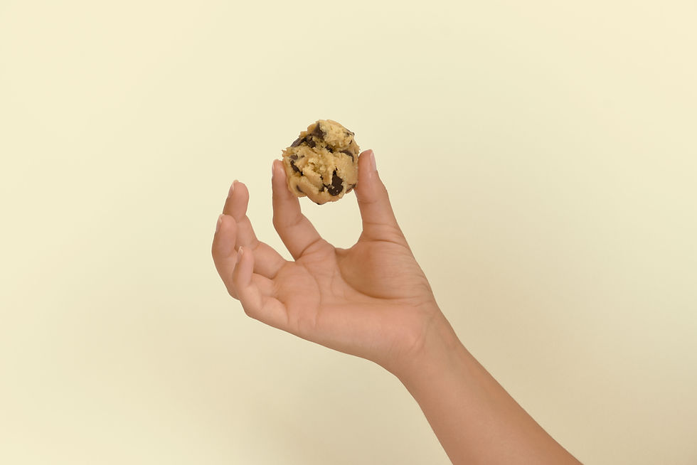 Hand holding a cookie, representing cookie choices and consent