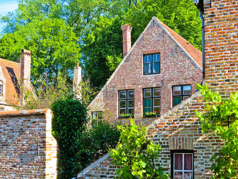 A traditional Cheshire brick house within a rural setting.