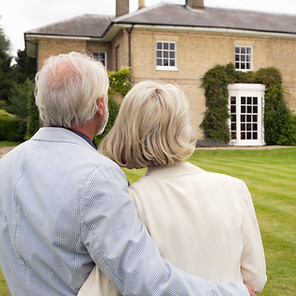Senior couple admiring house