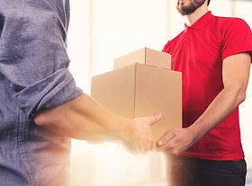 Man accepting a delivery of boxes from a delivery man