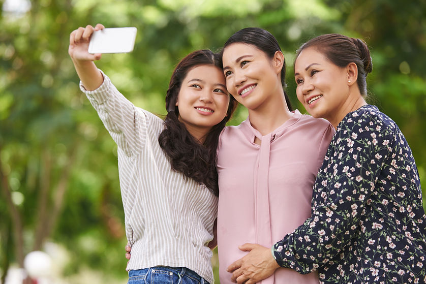 Three generations in an Asian family taking a selfie