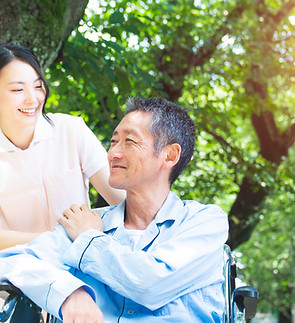 Elderly Patient In Wheelchair And Caregiver