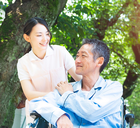 Elderly Patient In Wheelchair And Caregiver