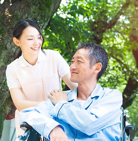 Elderly Patient In Wheelchair And Caregiver