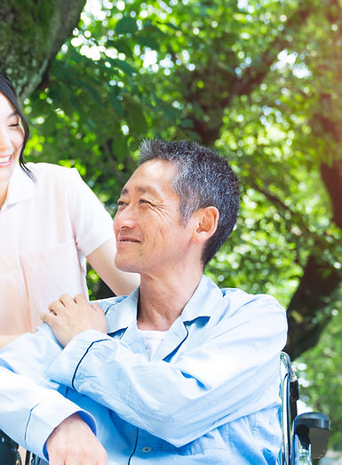 Elderly Patient In Wheelchair And Caregiver
