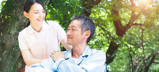 Elderly Patient In Wheelchair And Caregiver