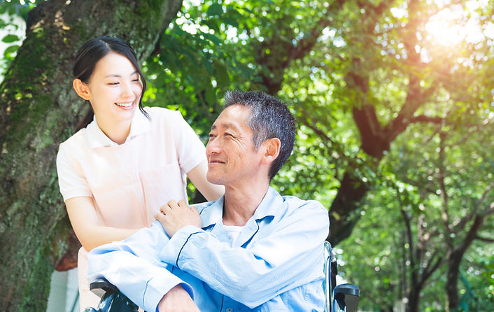 Elderly Patient In Wheelchair And Caregiver