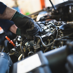 Close up hands of mechanic doing car service