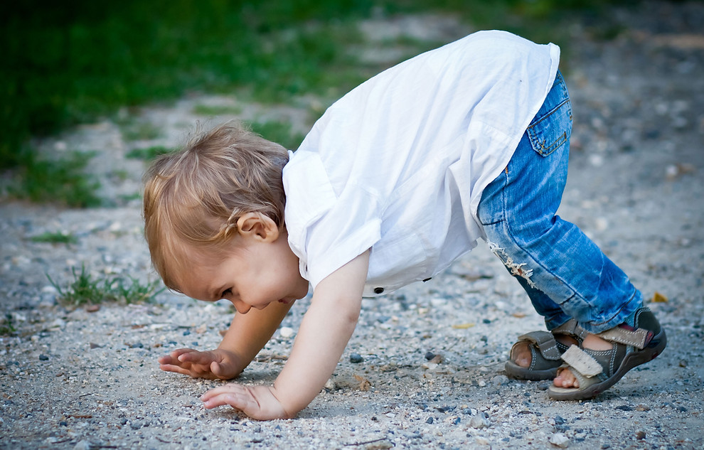 Enfant posant les mains au sol