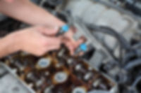Car mechanic fixing fuel injector