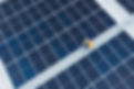 A staff checking solar panels