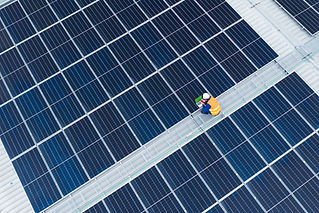 A staff checking solar panels
