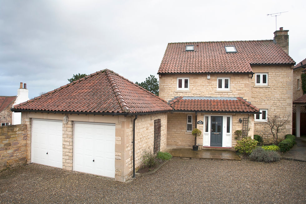 Detached home with an attached double garage and tiled roof
