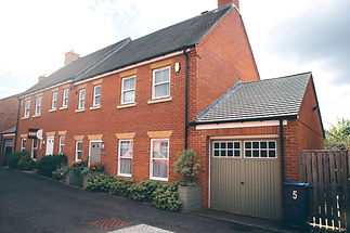 Landscape image of a house that has a 'Sold' sign on the front